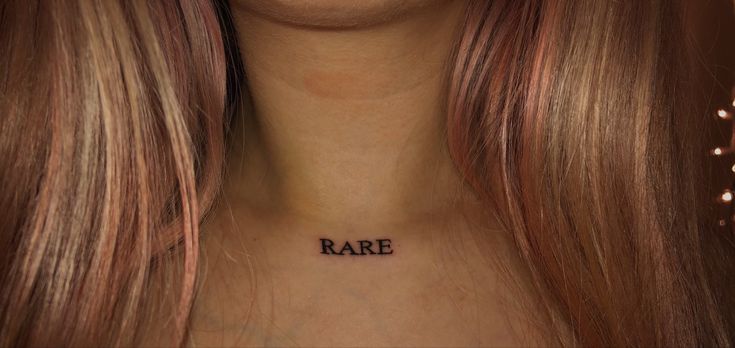 a woman's chest with the word rare tattooed on her left side neck and right breast