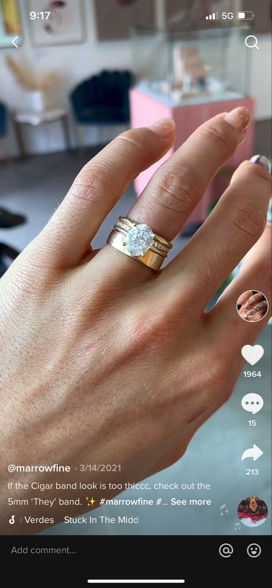 someone's hand with two different rings on it