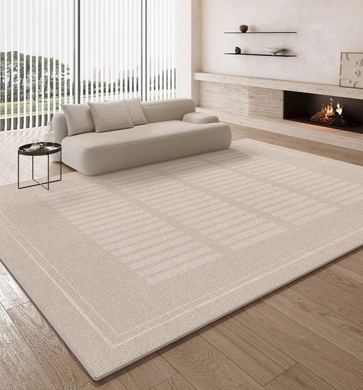 a living room with a couch, fireplace and large rug on the floor in front of it