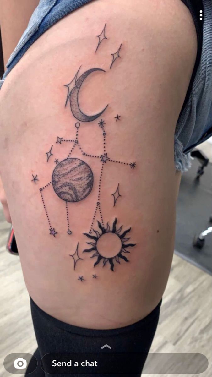 a woman's thigh with the sun and moon tattoos on her thighs, which are drawn