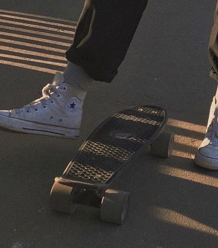 two people standing next to each other with their feet on skateboards