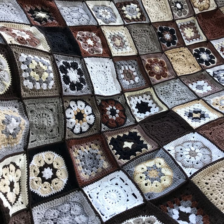 a crocheted blanket with many different colors and designs on it, all arranged in squares