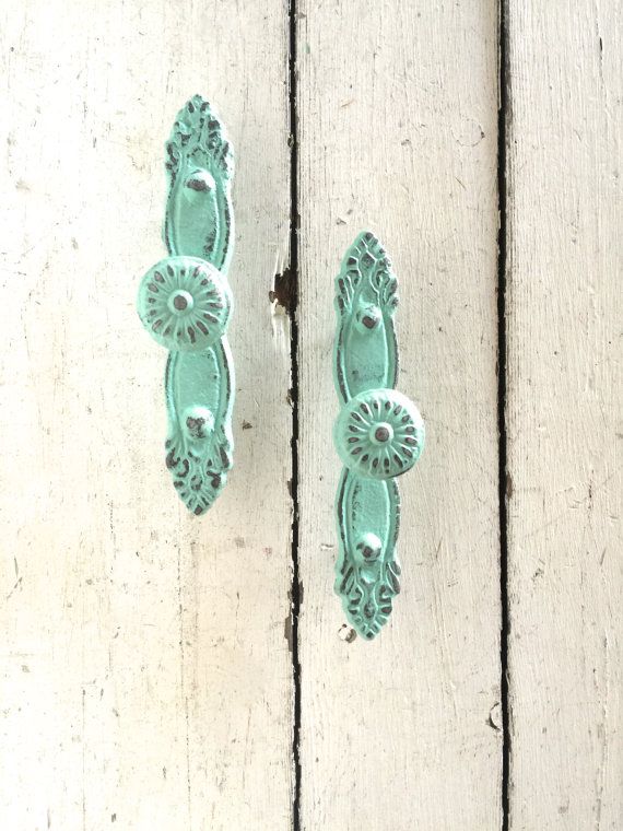 two green door handles on an old wooden door