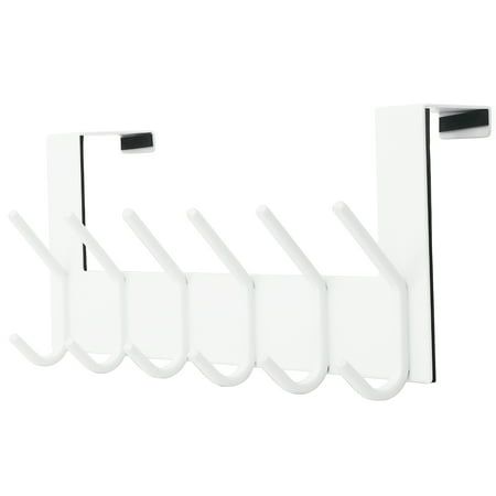 four white hooks hanging from the side of a wall