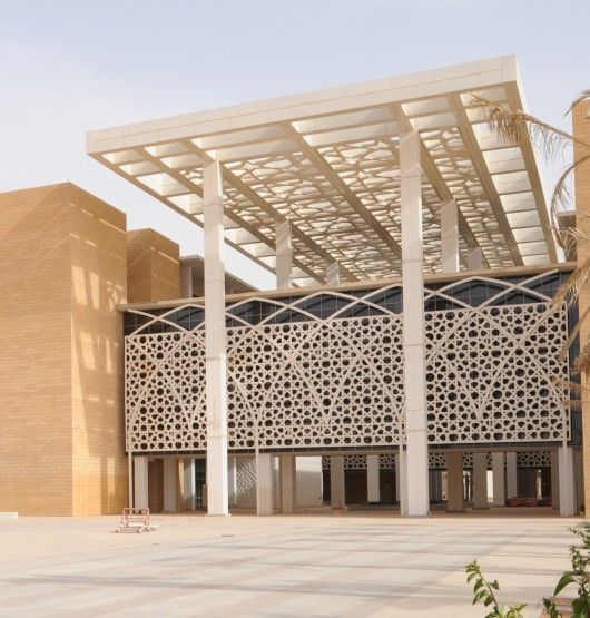 a large building with a white pergolated roof over it's entrance area