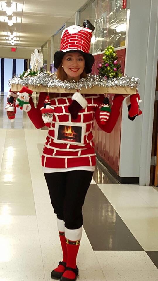 a woman dressed in red and black holding a tray with christmas decorations on top of her head