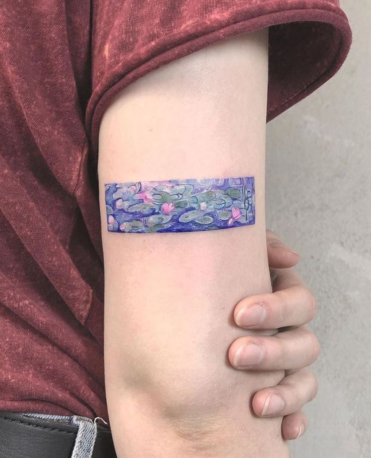 a woman's arm with a tattoo on it that has water lilies in the pond