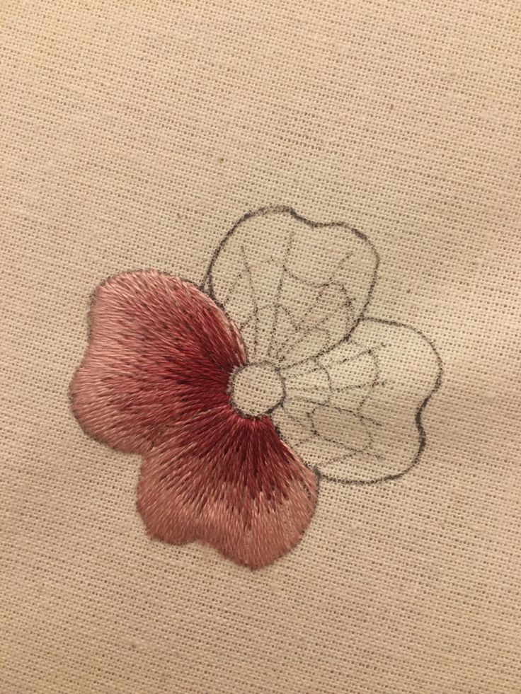 a close up of a piece of cloth with a flower embroidered on the back of it