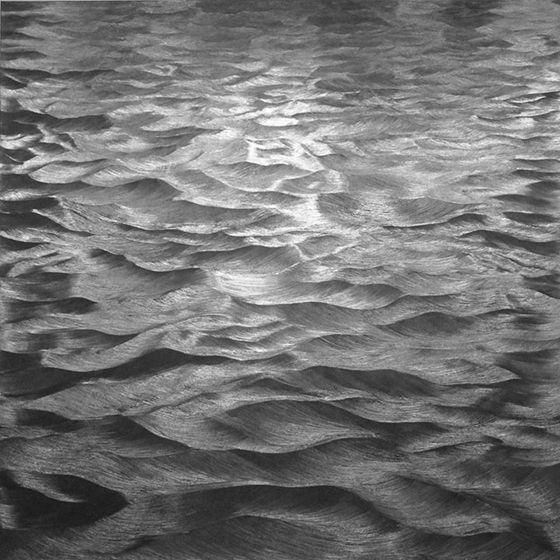 water ripples on the sand in black and white