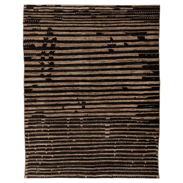 a black and brown rug with stripes on it