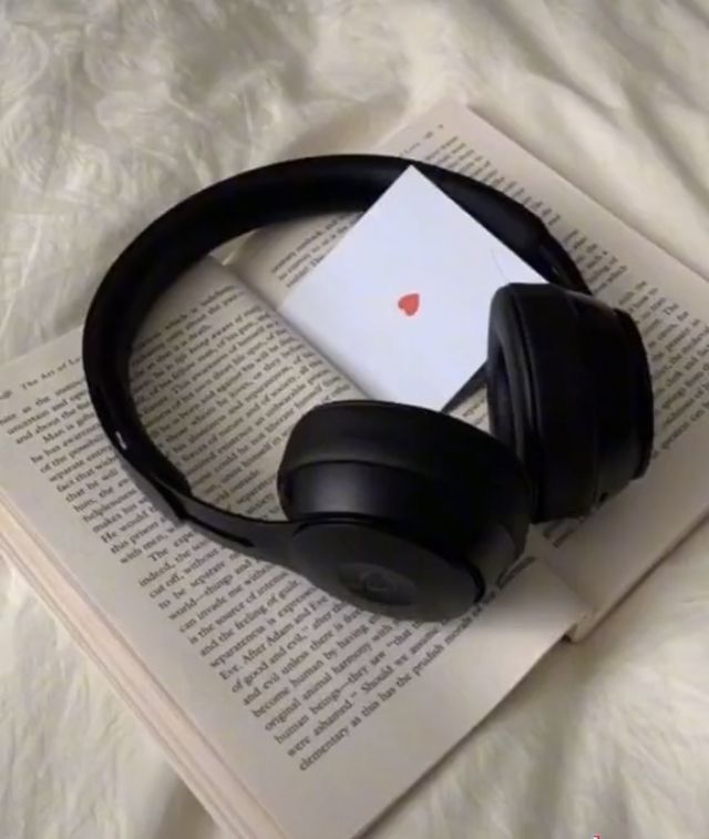 an open book with headphones on top of it