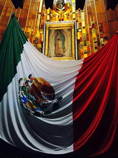 the mexican flag is draped in front of a painting