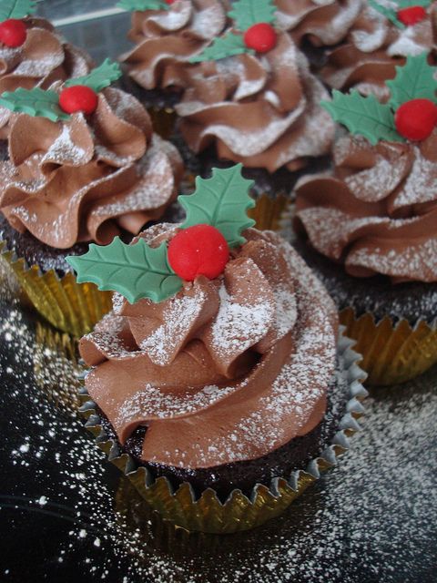 cupcakes with chocolate frosting and holly decorations