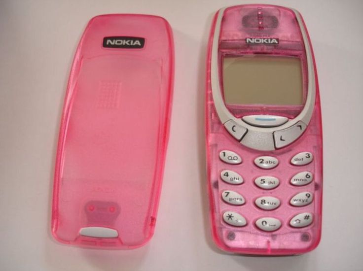 a pink nokia cell phone sitting on top of a white table next to a pink case