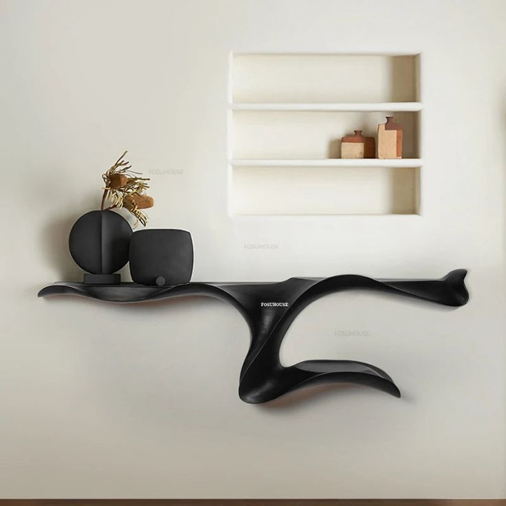 a black shelf with two vases on it