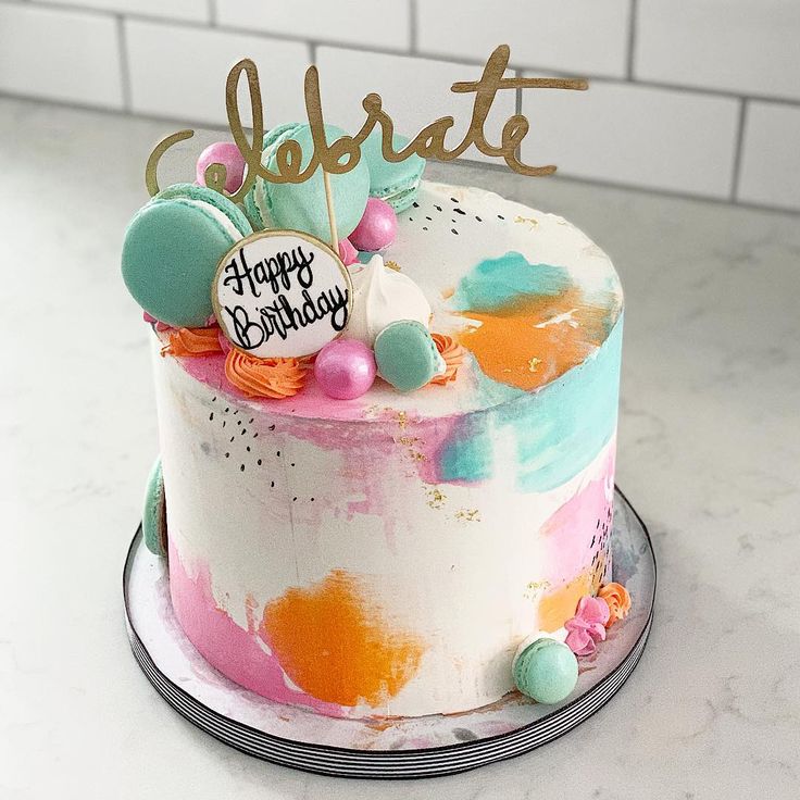 a birthday cake with colorful frosting and decorations on top that reads celebrate happy birthday