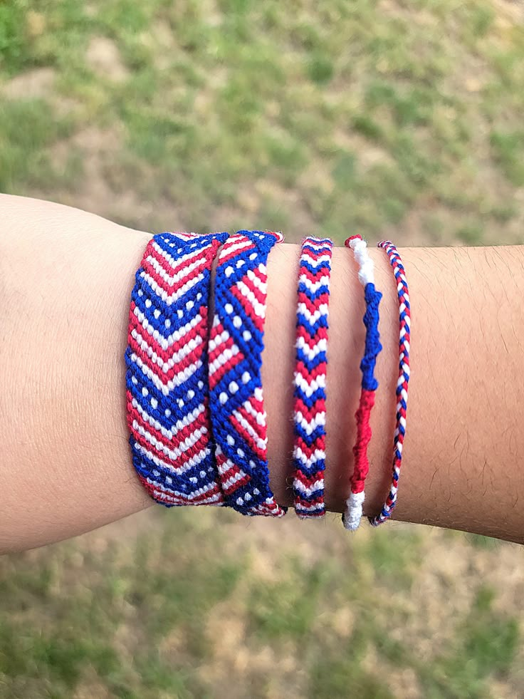 a person's arm with three bracelets on it, one is red white and blue