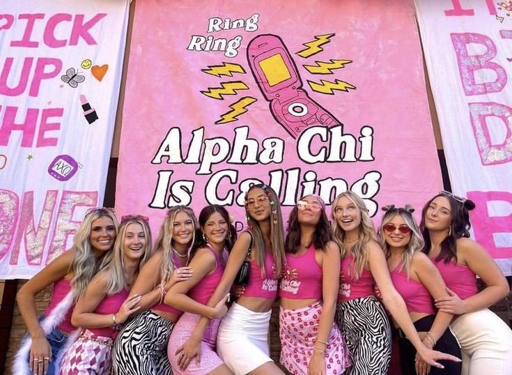 a group of women in pink shirts posing for a photo