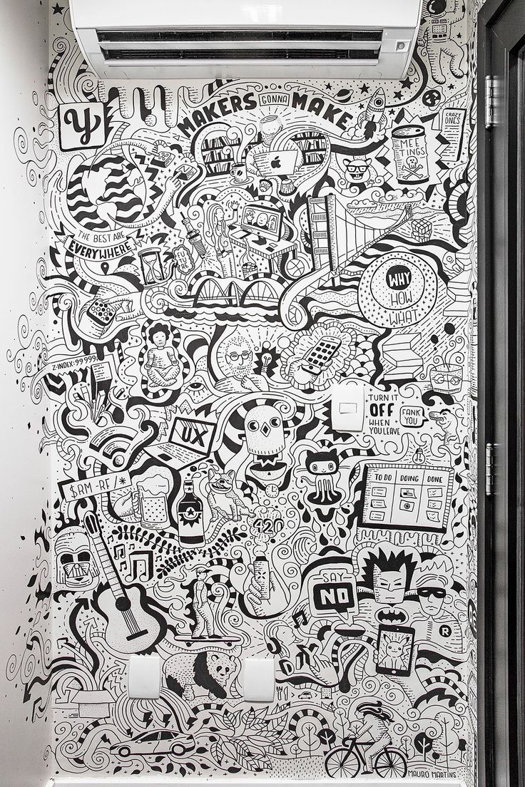 a bathroom with black and white doodles on the wall next to an air conditioner