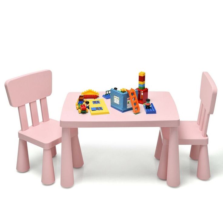 a pink table and two chairs with toys on it