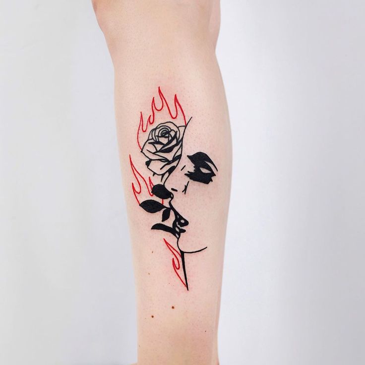 a woman with a rose tattoo on her leg