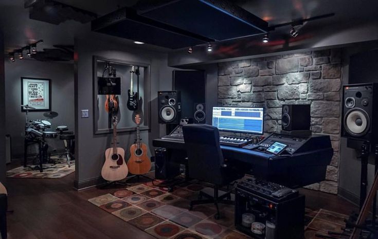 a home recording studio with guitars and sound equipment