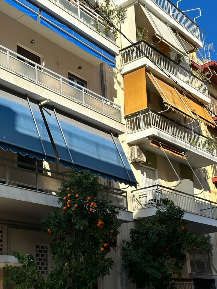 an apartment building with balconies and awnings