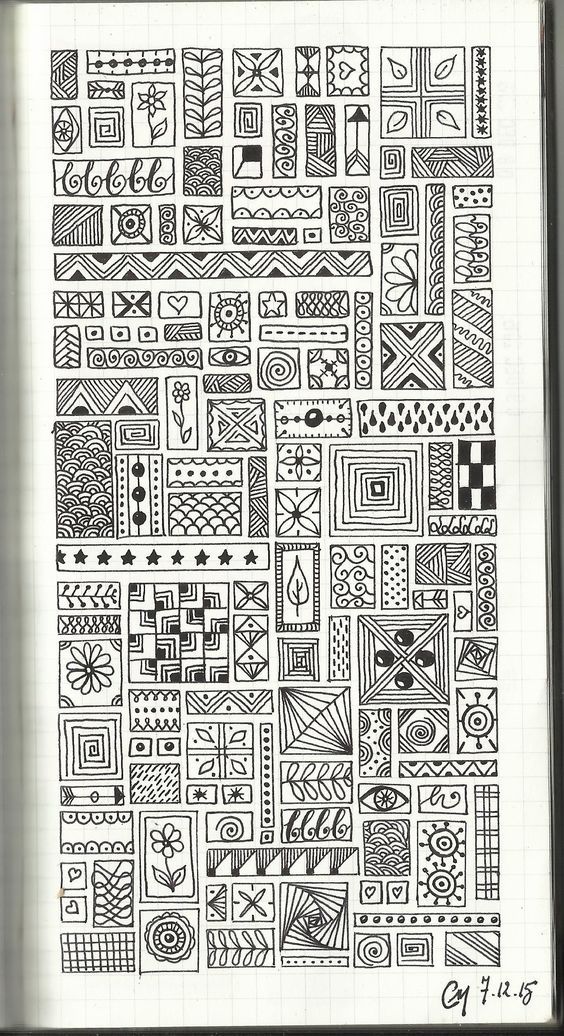 a notebook with an intricate pattern on the cover and some lines drawn in black ink