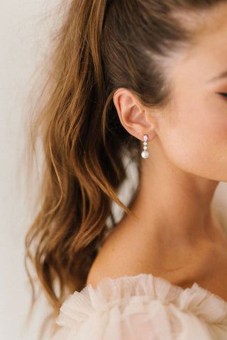 a close up of a person wearing some kind of earring on their left ear