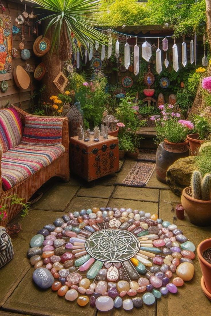 a garden with lots of plants and rocks on the ground in front of a couch