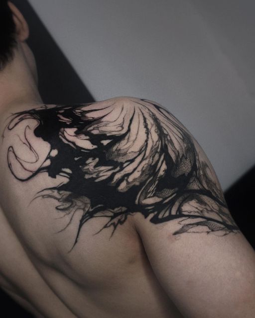 a man with black ink on his back