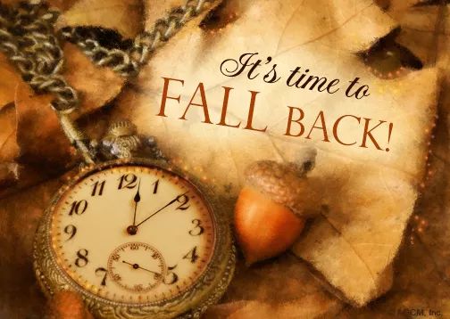 an old pocket watch with fall leaves and acorns on the background, says it's time to fall back