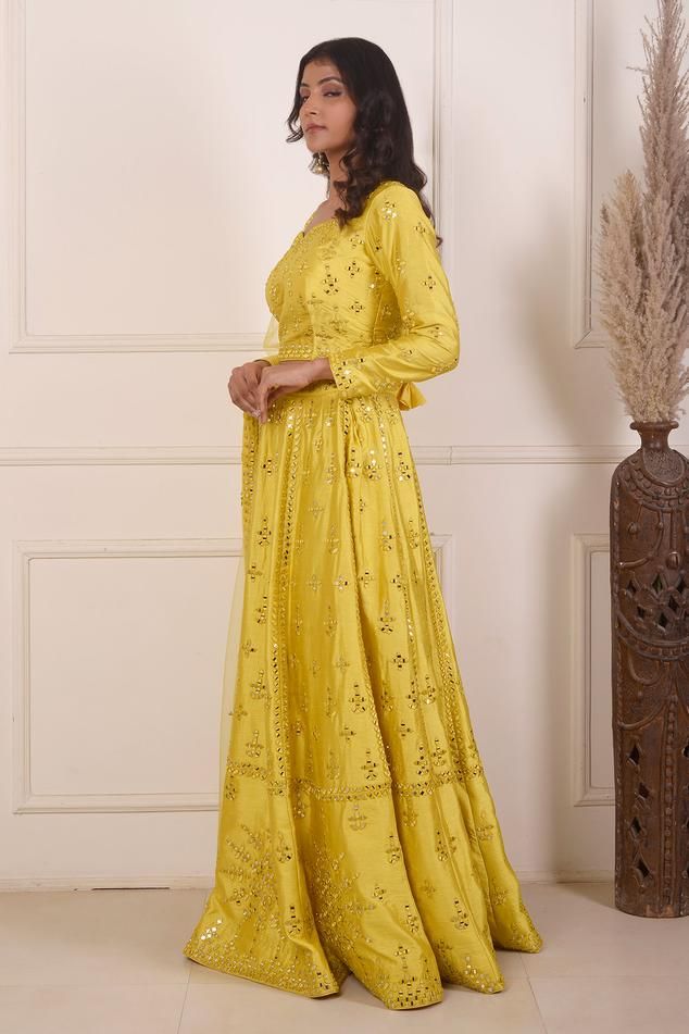 Yellow lehenga with mirror embroidery crafted in dupion. Paired with a long sleeve embroidered blouse and viscose net dupatta.
Components: 3
Pattern: Embroidered
Type Of Work: Mirror
Neckline: Leaf
Sleeve Type: Long
Fabric: Lehenga and Blouse: Dupion, Dupatta: Viscose Net
Color: Yellow
Other Details: 
Mirror work
Back tassel tie-up
Length:
Lehenga: 42 inches
Blouse: 15.5 inches
Dupatta: 2.5 mtrs
Occasion: Mehendi and Haldi - Aza Fashions Mirror Work Lehenga Choli, Lehenga And Blouse, Leaf Sleeve, Mirror Work Lehenga, Yellow Mirrors, Yellow Lehenga, Mirror Embroidery, Lehenga Blouse, Net Dupatta