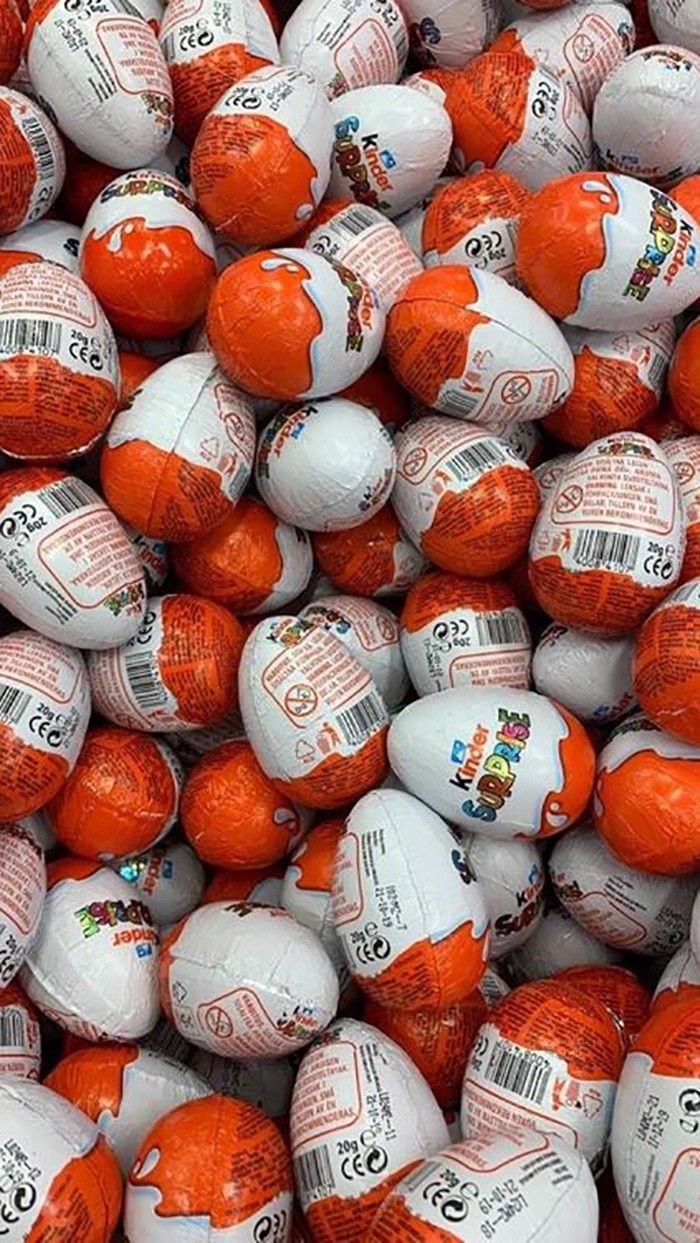 many orange and white balls are stacked together