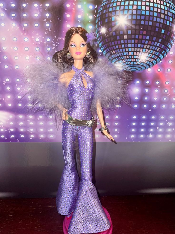 a barbie doll dressed in purple and holding a disco ball on the dancefloor