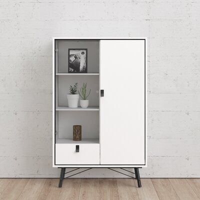 a white cabinet sitting on top of a wooden floor