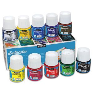 an assortment of different colors of acrylic paint in a display case with the box open