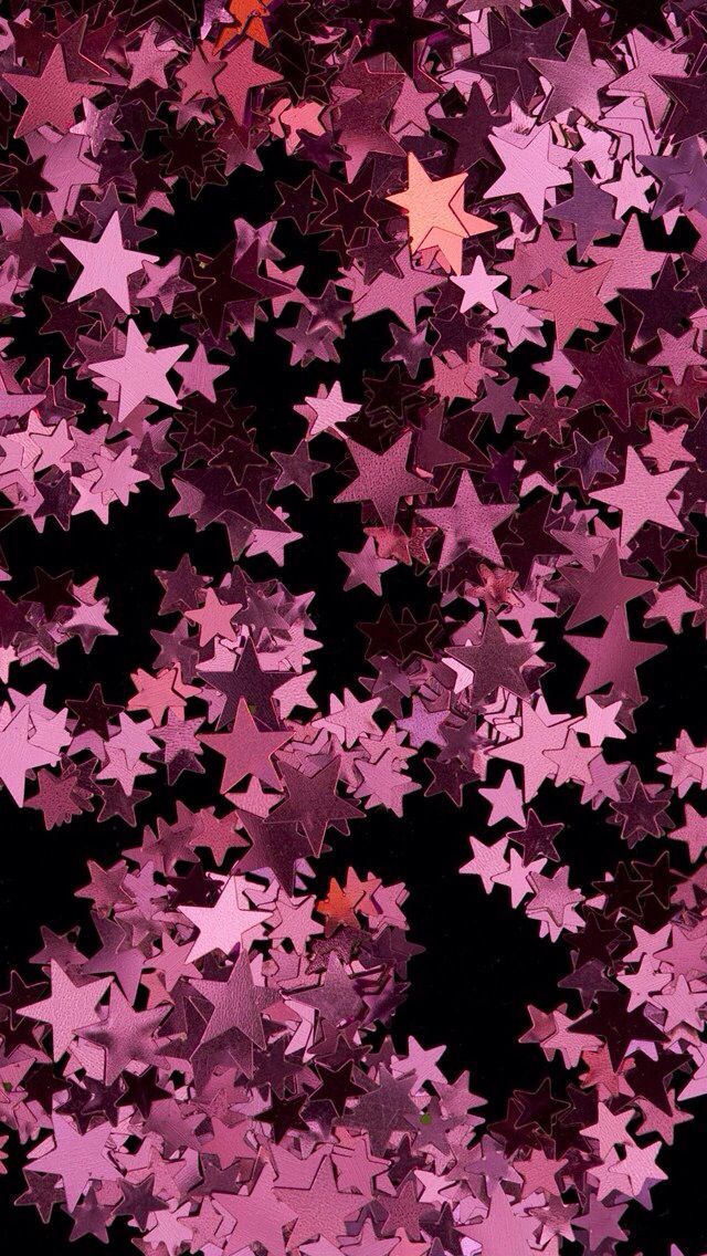 many pink stars are flying in the air