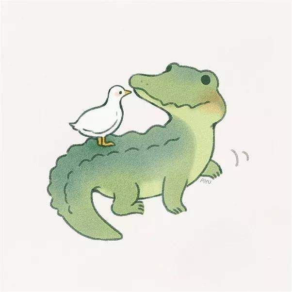 a white bird is standing on top of a green alligator's head and the crocodile has its beak in it's mouth