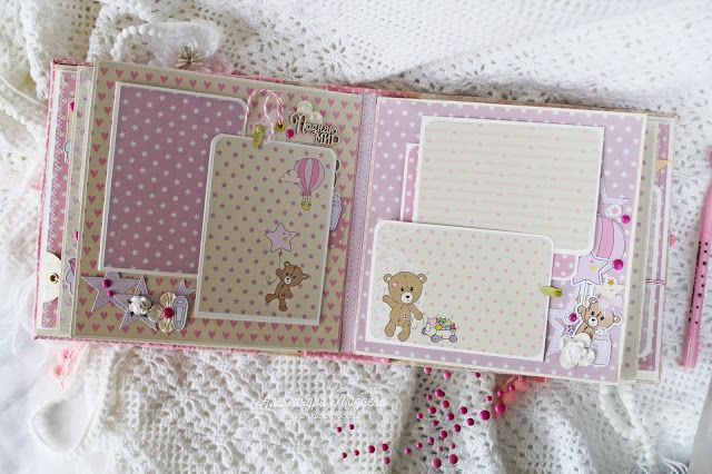 an open scrapbook with teddy bears and polka dots on the pages is laying on a bed