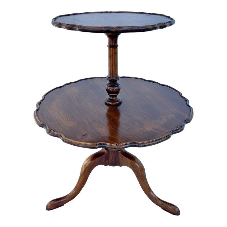 a wooden table with two tiered trays on each side and an oval glass top