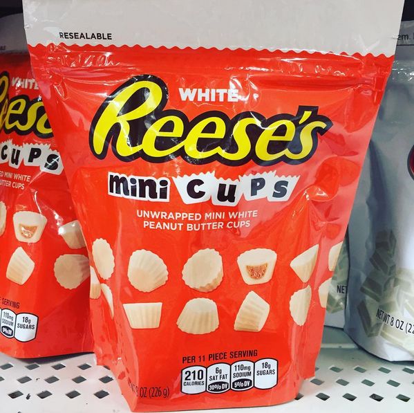 two bags of reese's mini cups are sitting on the shelf next to each other