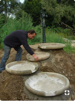 a man placing cement plates on top of a hill