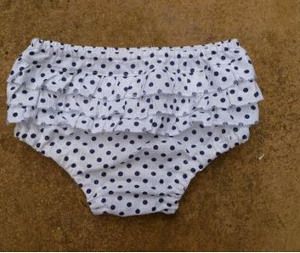 a white and black polka dot diaper on the ground