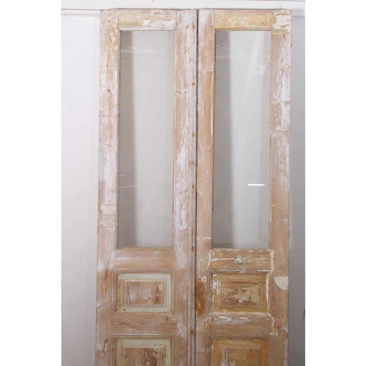 an old wooden door with two glass panels