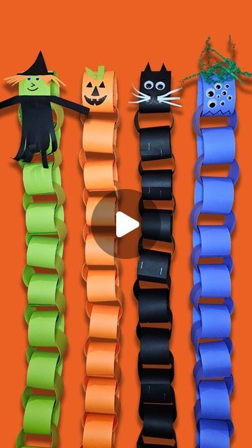 four halloween bracelets with cats and witches on them, hanging from a line in front of an orange background