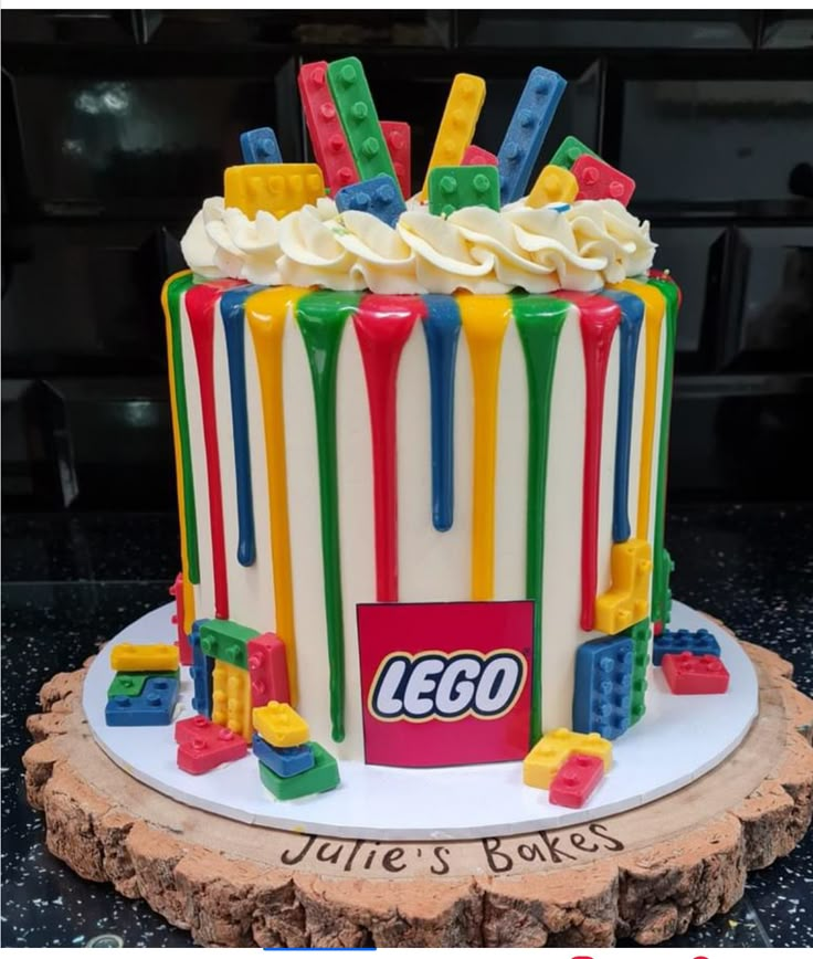 a lego themed cake with white frosting and multicolored icing