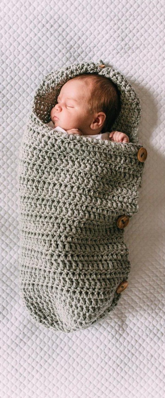 a newborn baby wrapped in a crochet blanket