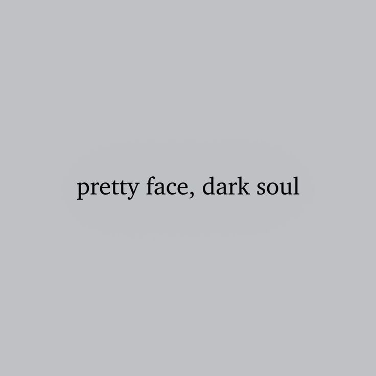 the words pretty face, dark soul are written in black ink on a gray background