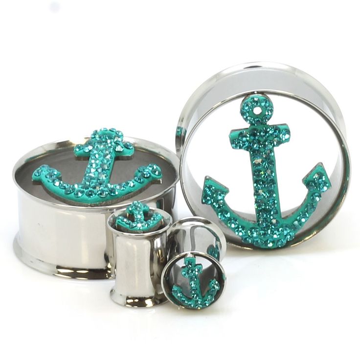 an anchor ring with green glitter on it and the words stainless steel tiffany anchor ear gauges